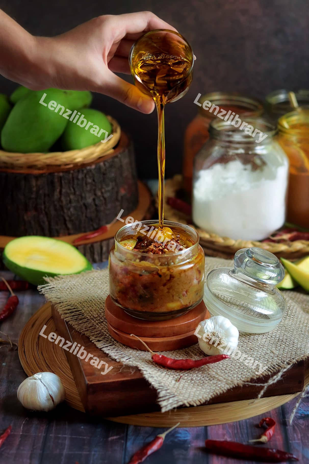 A person pouring an oil on a spicy jar